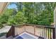 Back porch featuring brown railings and a patio area with an outdoor rug, perfect for relaxing and enjoying the outdoor space at 734 Frasier Se Cir, Marietta, GA 30060