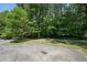 Spacious backyard with a patio area surrounded by lush greenery and trees at 734 Frasier Se Cir, Marietta, GA 30060