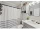 Cozy bathroom featuring a vanity with a sink, a toilet, and a shower with a curtain and shelving at 734 Frasier Se Cir, Marietta, GA 30060