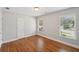 Spacious bedroom featuring hardwood floors, windows with blinds, and ample natural light for a comfortable feel at 734 Frasier Se Cir, Marietta, GA 30060