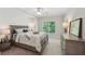 Cozy bedroom featuring a comfortable bed, dresser, and a large window with a view of lush greenery at 734 Frasier Se Cir, Marietta, GA 30060