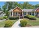 Charming home featuring a landscaped front yard and a cozy front porch at 734 Frasier Se Cir, Marietta, GA 30060