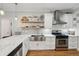 Well-lit kitchen with stainless steel appliances, hardwood floors, and ample counter space at 734 Frasier Se Cir, Marietta, GA 30060