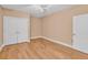 Bedroom with light beige walls, wood flooring, and a double door closet at 799 Hammond Dr # 314, Atlanta, GA 30328