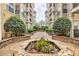 Manicured courtyard with lush greenery, stone planters, and benches at 799 Hammond Dr # 314, Atlanta, GA 30328