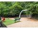 Community dog park with various play structures and a bench for pet owners at 799 Hammond Dr # 314, Atlanta, GA 30328