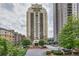 High-rise condo building showcasing manicured landscaping and covered parking at 799 Hammond Dr # 314, Atlanta, GA 30328