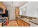 Well-lit kitchen with wood cabinets, granite countertops, stainless steel appliances, and a breakfast bar at 799 Hammond Dr # 314, Atlanta, GA 30328