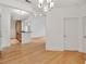Open-concept living space with hardwood flooring, featuring kitchen and door access at 799 Hammond Dr # 314, Atlanta, GA 30328