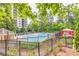 Community pool with surrounding trees and a red gazebo for outdoor seating at 799 Hammond Dr # 314, Atlanta, GA 30328