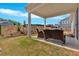 This backyard features a covered patio, professionally installed sod and landscaping, and neighborhood views at 127 Laurel Farms Ln, Dallas, GA 30157