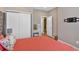 This bedroom features double closets, an adjacent vanity, and a mount for a flat-screen TV at 127 Laurel Farms Ln, Dallas, GA 30157