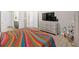 Comfortable bedroom with hardwood floors and large TV at 127 Laurel Farms Ln, Dallas, GA 30157