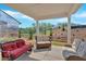 The covered patio has modern furniture, a recessed ceiling, and outdoor views at 127 Laurel Farms Ln, Dallas, GA 30157
