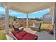 The covered patio has stylish furniture, views of the lawn, and neighborhood views at 127 Laurel Farms Ln, Dallas, GA 30157