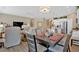 Open-concept living space featuring a modern dining table and a view into the kitchen at 127 Laurel Farms Ln, Dallas, GA 30157