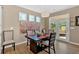 Bright dining room with a modern table setting, stylish chairs, and a patio view at 127 Laurel Farms Ln, Dallas, GA 30157