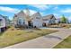 Beautifully landscaped home with a two-car garage, stone accents, and a lush green lawn at 127 Laurel Farms Ln, Dallas, GA 30157