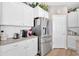 Modern kitchen with stainless steel appliances, ample counter space, and pantry at 127 Laurel Farms Ln, Dallas, GA 30157