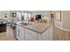 Granite kitchen island with seating for two and a view of the living room at 127 Laurel Farms Ln, Dallas, GA 30157