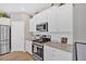 Contemporary kitchen featuring granite counters, stainless steel appliances, and white cabinetry at 127 Laurel Farms Ln, Dallas, GA 30157
