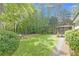 Large, grassy backyard with mature trees and a view of the screened in porch at 1391 Arden Sw Dr, Marietta, GA 30008