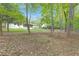 Green backyard features a well-maintained lawn, mature trees, and views of the home's rear exterior at 1391 Arden Sw Dr, Marietta, GA 30008