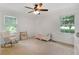 Sun-lit bedroom features a rocking chair, reading rack and bed next to bright sunny windows at 1391 Arden Sw Dr, Marietta, GA 30008