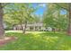 Charming single-story home with a well-manicured lawn and lush trees at 1391 Arden Sw Dr, Marietta, GA 30008