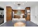 Charming kitchen featuring wood cabinets, stainless steel appliances, and a view into the living room at 1391 Arden Sw Dr, Marietta, GA 30008