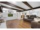 Spacious living room featuring hardwood floors, beamed ceilings, and built-in shelving at 1391 Arden Sw Dr, Marietta, GA 30008