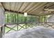 Relaxing screened-in porch with a stone tile floor and a beautiful view of the wooded backyard at 1391 Arden Sw Dr, Marietta, GA 30008