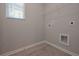 Laundry room with a window, shelving, and gray painted walls at 492 Charleston Pl, Villa Rica, GA 30180