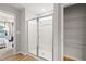 Bright bathroom featuring a glass shower and a convenient walk-in closet at 8214 Tiger Way, Riverdale, GA 30296