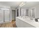 Modern bathroom with double vanity, granite countertop, and a glass-enclosed shower at 8214 Tiger Way, Riverdale, GA 30296