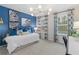 Stylish bedroom featuring a blue accent wall, zebra artwork, and bright natural light at 8214 Tiger Way, Riverdale, GA 30296