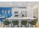 Modern kitchen featuring a large island with seating, stainless appliances, and white cabinetry at 8214 Tiger Way, Riverdale, GA 30296