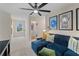 Cozy living space with a plush blue sofa, cool artwork, and a view into the laundry room at 8214 Tiger Way, Riverdale, GA 30296
