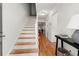 Bright entryway with hardwood floors and staircase leading to upper level at 113 Courtyard Ter, Roswell, GA 30075