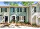Charming two-story townhouse with black shutters and manicured landscaping at 113 Courtyard Ter, Roswell, GA 30075