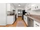 Modern kitchen with granite countertops and stainless steel appliances, opens to living space at 113 Courtyard Ter, Roswell, GA 30075