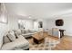 Open-concept living and dining area with hardwood floors and ample seating at 113 Courtyard Ter, Roswell, GA 30075