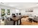 Elegant living and dining space with hardwood floors and access to outdoor space at 113 Courtyard Ter, Roswell, GA 30075