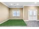 Basement features putting green and neutral paint with a double door exit at 1584 Fernstone Nw Cir, Acworth, GA 30101