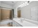 Bathroom features a shower-tub combo, a white vanity and modern fixtures at 1584 Fernstone Nw Cir, Acworth, GA 30101