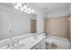 Bathroom featuring a double sink vanity, tub with shower, and a large mirror at 1584 Fernstone Nw Cir, Acworth, GA 30101