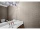 Powder room boasts patterned wallpaper, a decorative mirror and a single sink vanity at 1584 Fernstone Nw Cir, Acworth, GA 30101