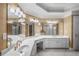 Bathroom with double vanity, white cabinets, and shower reflected in the mirror at 1584 Fernstone Nw Cir, Acworth, GA 30101
