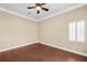 Bedroom with ceiling fan, window with blinds, and hardwood flooring at 1584 Fernstone Nw Cir, Acworth, GA 30101