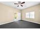 Bedroom with ceiling fan, large window, and grey carpet at 1584 Fernstone Nw Cir, Acworth, GA 30101